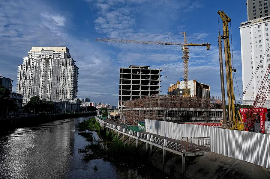 This general view shows labourers working at the construction site of a building in Phnom Penh on 5 September 2024. (Tang Chhin Sothy/AFP)