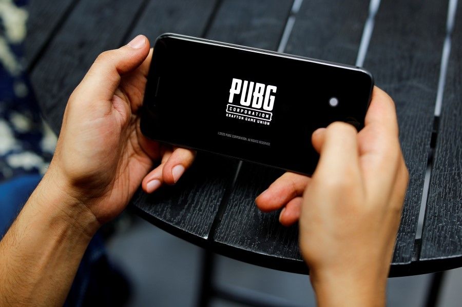 A user plays Tencent Holdings' PUBG videogame on a mobile phone, 3 September 2020. (Adnan Abidi/Reuters)