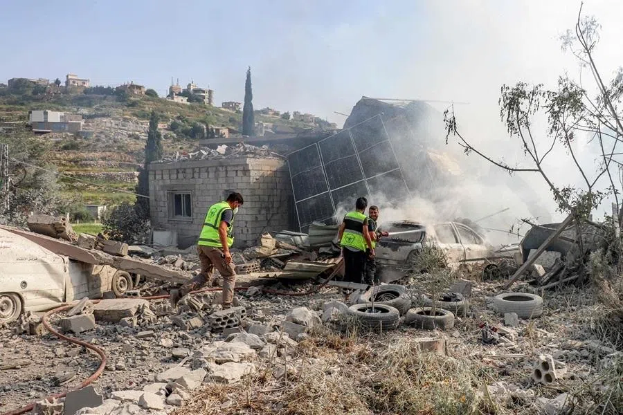 First responders affiliated with the Islamic Risala Scout Association gather at the scene following Israeli bombardment that hit one of their facilities in the village of Arnoun in southern Lebanon on 12 May 2026. (AFP)
