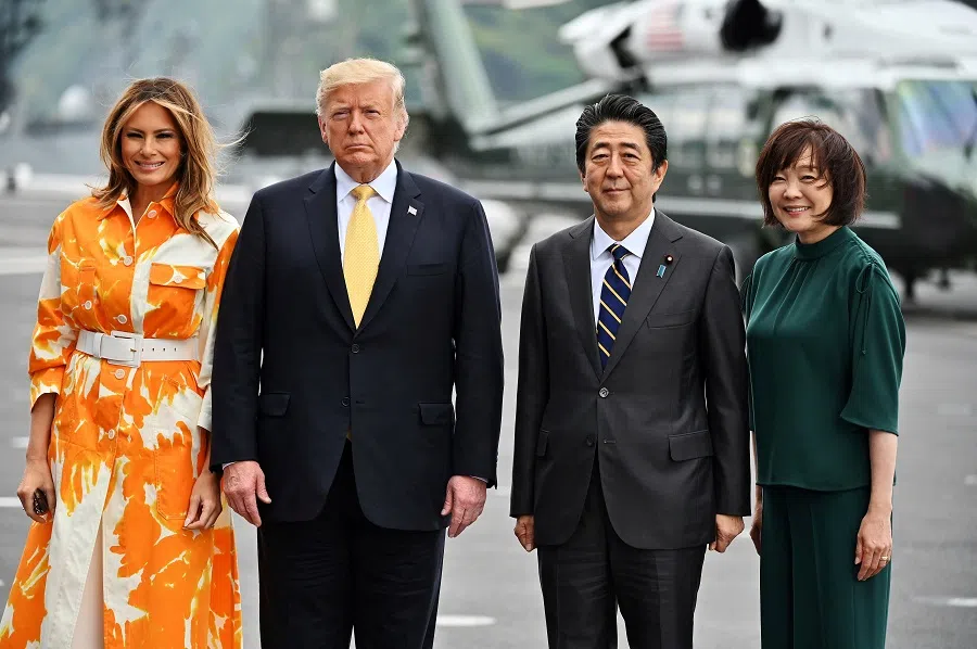 US President Donald Trump, first lady Melania Trump, then Japanese Prime Minister Shinzo Abe and wife Akie Abe onboard Japan’s navy ship Kaga on 28 May 2019 in Yokosuka, Japan. (Charly Triballeau/Pool via Reuters)