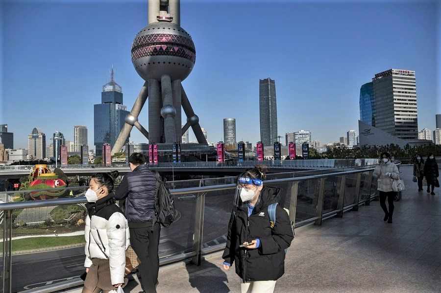 Pedestrians in the Lujiazui financial district in Shanghai, China, on 20 December 2022. (Qilai Shen/Bloomberg)
