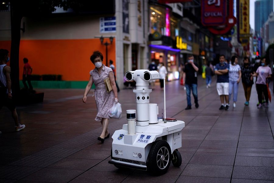 A police robot keeps watch on a shopping street in Shanghai, following the Covid-19 outbreak, on 16 June 2020. (Aly Song/Reuters)