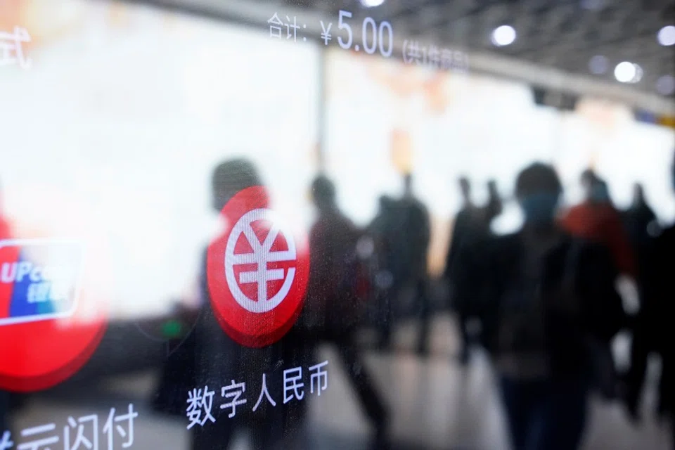 A sign indicating digital RMB is pictured on a vending machine at a subway station in Shanghai, China, 21 April 2021. (Aly Song/Reuters)