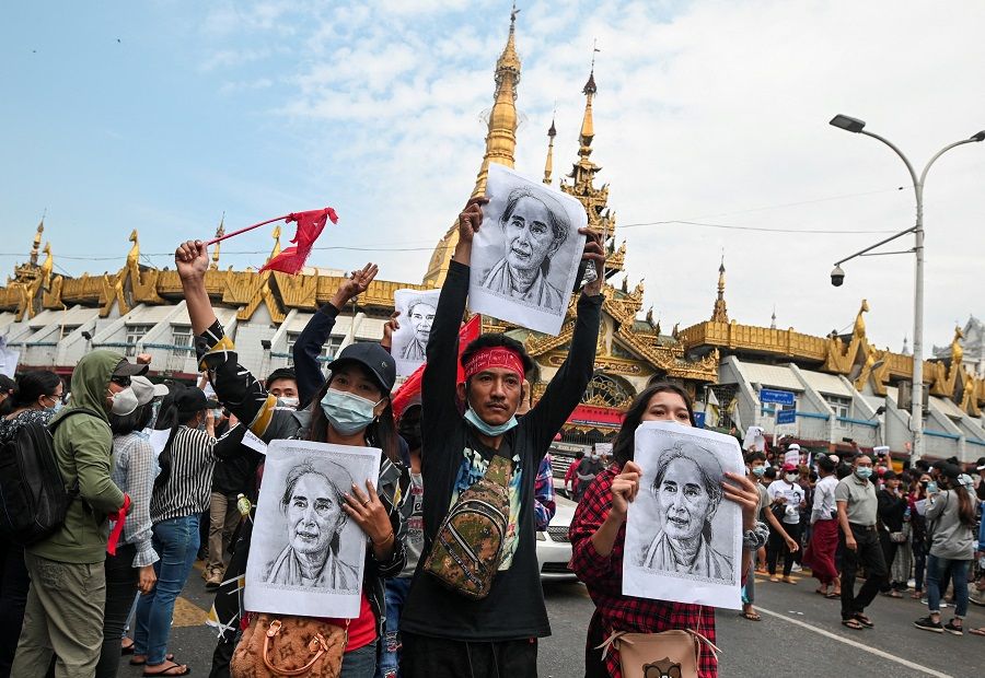 People hold placards depicting leader Aung San Suu Kyi during a rally to demand her release and protest against the military coup, in Yangon, Myanmar, 8 February 2021. (Stringer/File Photo/Reuters)