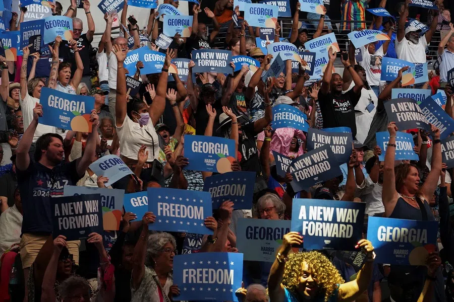 Attendees show signs during a campaign rally held by Democratic presidential nominee and US Vice-President Kamala Harris, in Savannah, Georgia, US, on 29 August 2024. (Megan Varner/Reuters)