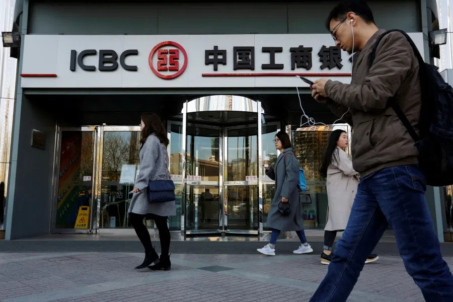 People walk past a branch of the Industrial and Commercial Bank of China (ICBC) in Beijing, China, 1 April 2019. (Florence Lo/Reuters)