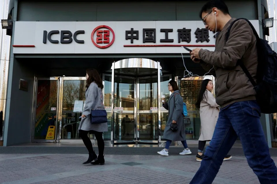 People walk past a branch of the Industrial and Commercial Bank of China (ICBC) in Beijing, China, 1 April 2019. (Florence Lo/Reuters)