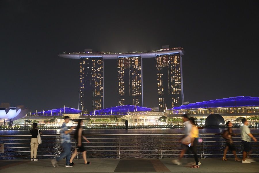 People walk along Fullerton Bay in Singapore. (SPH Media)