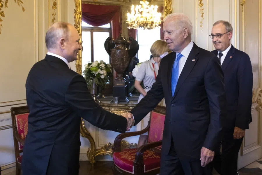 Russian President Vladimir Putin (left) and US President Joe Biden (centre) shake hands as Swiss President Guy Parmelin looks on at the start of the US-Russia summit at Villa La Grange in Geneva, Switzerland on 16 June 2021. (Peter Klaunzer/Swiss Federal Office of Foreign Affairs/Bloomberg)