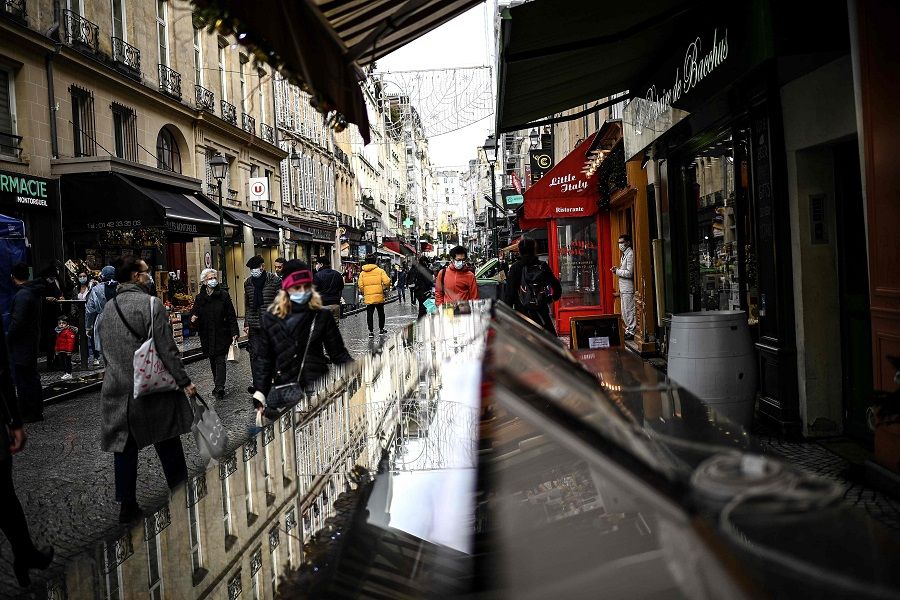 People walk along a commercial street in central Paris, France, on 23 December 2020. (Christophe Archambault/AFP)