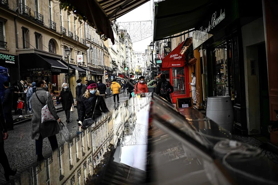 People walk along a commercial street in central Paris, France, on 23 December 2020. (Christophe Archambault/AFP)