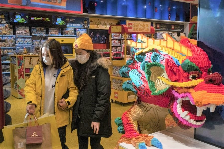 Customers walk past a dragon made from Lego bricks at a store in Beijing, China, on 7 December 2020. (Gilles Sabrie/Bloomberg)