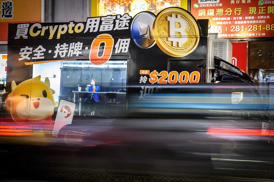 An employee sits inside a Bitcoin exchange advertisement truck in Hong Kong on 27 November 2024. (Mladen Antonov/AFP)
