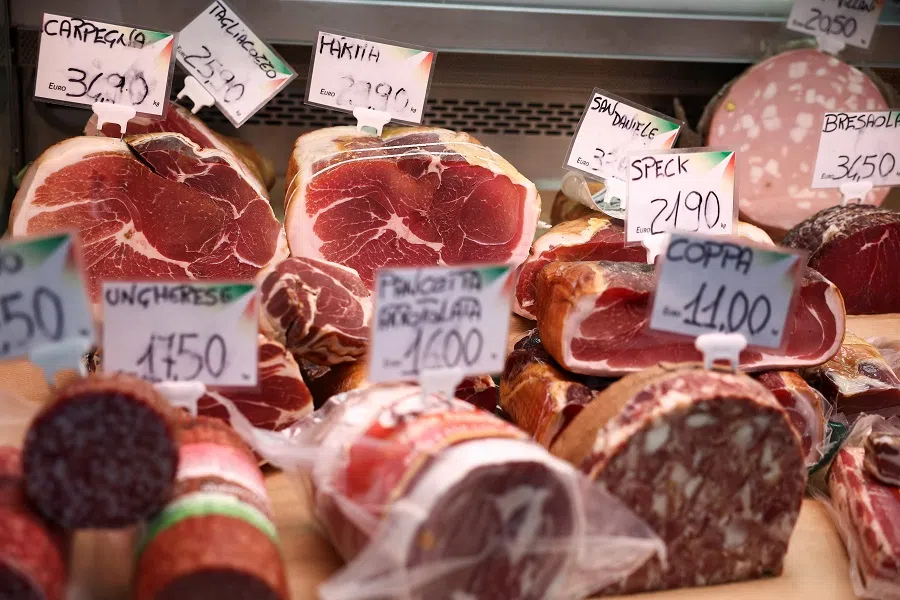 Cured meat products made with pork are displayed at a market stall in Rome, Italy on 17 June 2024.