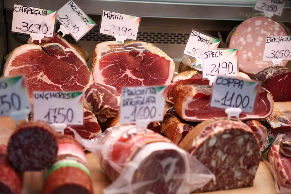 Cured meat products made with pork are displayed at a market stall in Rome, Italy on 17 June 2024. (Guglielmo Mangiapane/Reuters)