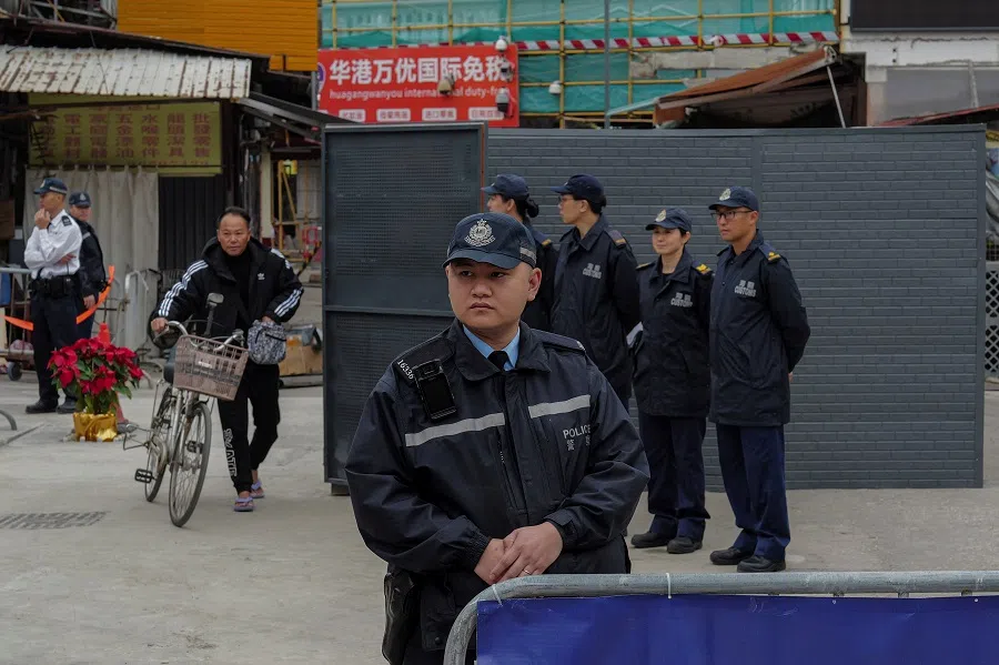 Police and Customs officers stand guard at Chung Ying Street checkpoint, a border street where one side belongs to Hong Kong and the other to Chinese Shenzhen, during a media tour in Hong Kong, China, 23 December 2024. (Tyrone Siu/Reuters)