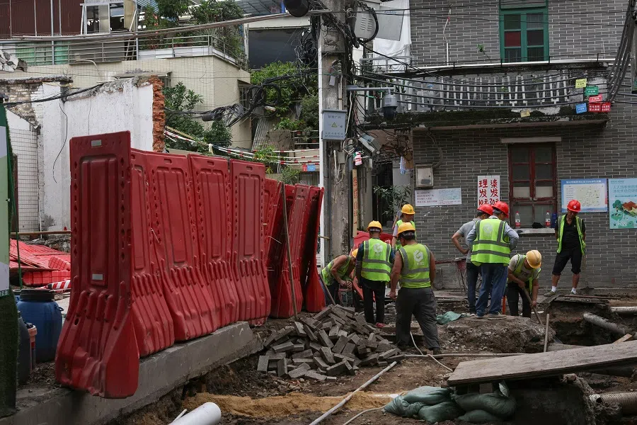 Construction workers dig the ground in Guangzhou, Guangdong province, China, on 8 May 2025. (Go Nakamura/Reuters)