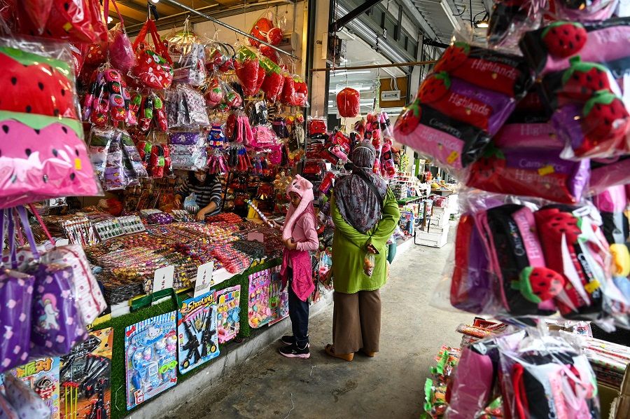 A girl buys souvenirs at the Kea Farm in Cameron Highlands near Brinchang in Malaysia's Pahang state on 28 November 2020. (Mohd Rasfan/AFP)