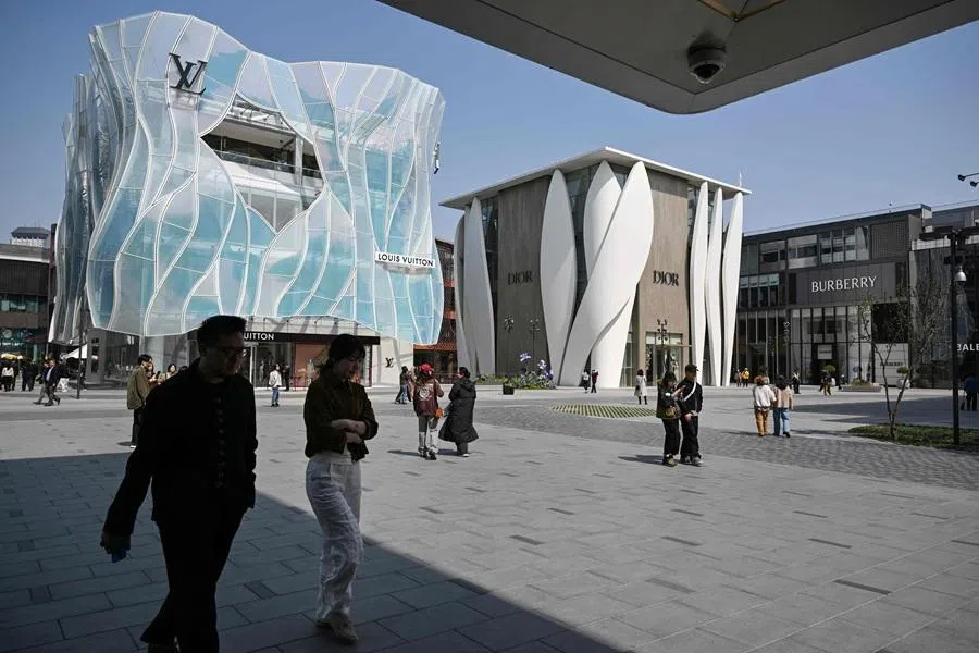 People visit a shopping centre in Beijing on 2 April 2026. (Adek Berry/AFP)