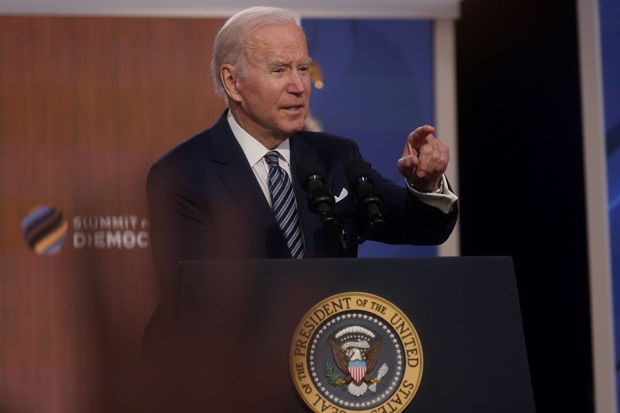 US President Joe Biden takes questions from reporters after delivering closing remarks at the virtual Summit for Democracy, Eisenhower Executive Office Building's South Court Auditorium, Washington, US, 10 December 2021. (Leah Millis/Reuters)