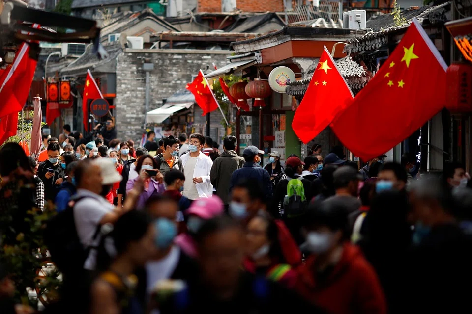 People walk in the tourist area surrounding Houhai Lake during Chinese National Day holidays in Beijing, China, 2 October 2020. (Thomas Peter/Reuters)