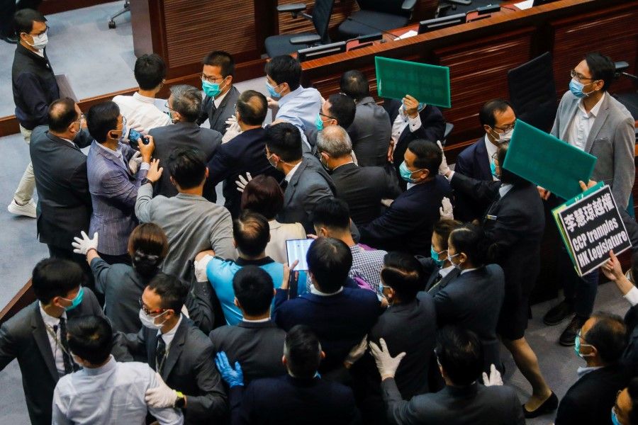 Pan-democratic legislators scuffle with security as they protest against new security laws during Legislative Council's House Committee meeting, in Hong Kong, 22 May 2020. (Tyrone Siu/REUTERS)