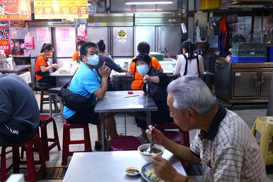 People eat at a dumpling restaurant in Keelung, Taiwan, 23 May 2022. (Ann Wang/Reuters)