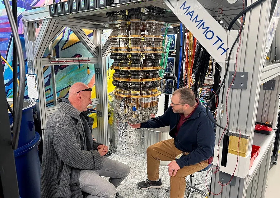 Google Quantum AI’s Hartmut Neven (left) and Anthony Megrant (right) examine a cryostat refrigerator for cooling quantum computing chips at Google’s Quantum AI lab in Santa Barbara, California, US, on 25 November 2024. (Stephen Nellis/Reuters)