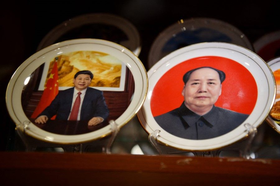 Souvenir plates featuring Chinese President Xi Jinping (left) and late communist leader Mao Zedong are seen at a store in Beijing on 2 March 2021. (Greg Baker/AFP)