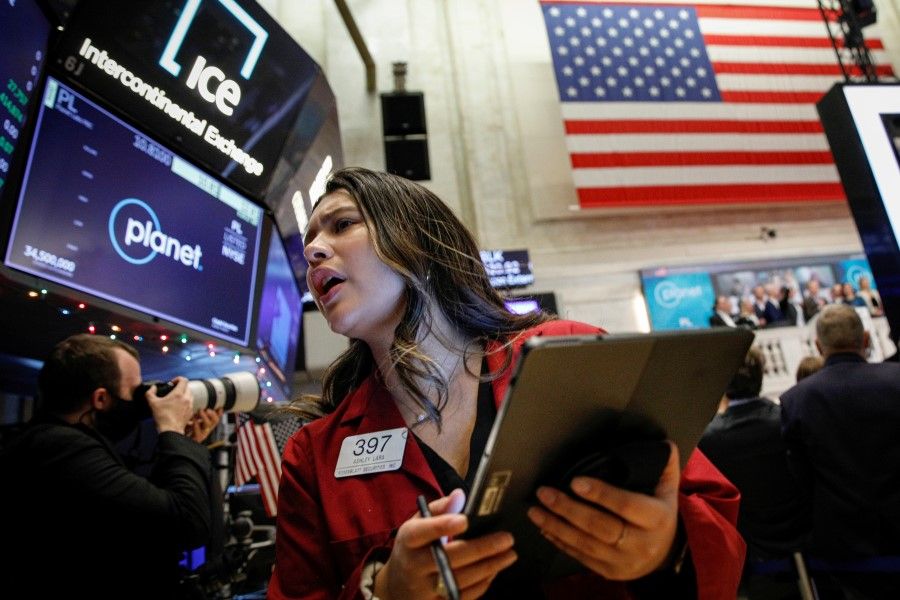 Traders work on the floor of the New York Stock Exchange (NYSE) in New York City, US, 8 December 2021. (Brendan McDermid/Reuters)
