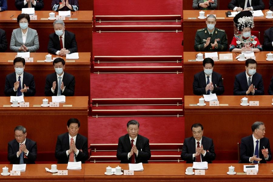Chinese President Xi Jinping, Premier Li Keqiang, National People's Congress (NPC) Standing Committee chairman Li Zhanshu, Chinese People's Political Consultative Conference chairman Wang Yang and Politburo Standing Committee member Li Qiang applaud at the opening session of the NPC at the Great Hall of the People in Beijing, China, 5 March 2023. (Thomas Peter/Reuters)