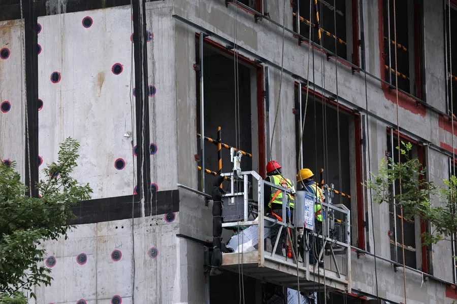 People work at a residential building under construction in Beijing, China on 16 October 2025. (Tingshu Wang/Reuters)