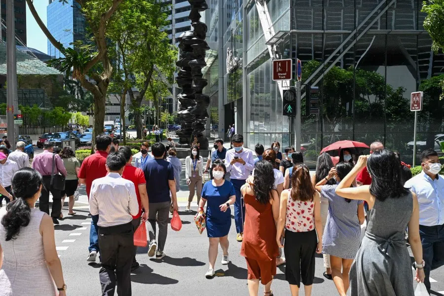 Office workers at Raffles Place financial business district in Singapore on 10 May 2022. (Roslan Rahman/AFP)