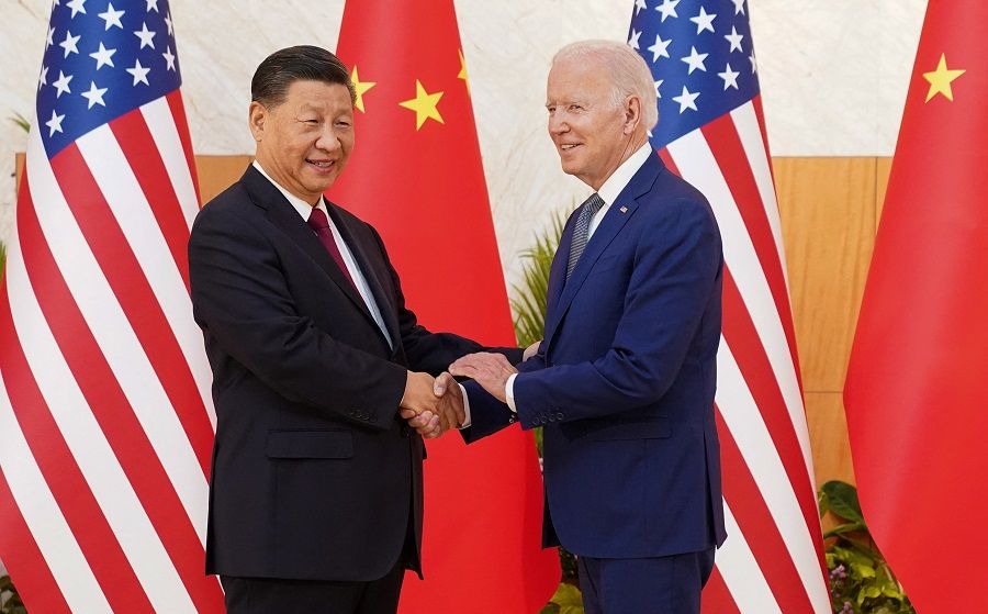 US President Joe Biden shakes hands with Chinese President Xi Jinping as they meet on the sidelines of the G20 summit in Bali, Indonesia, 14 November 2022. (Kevin Lamarque/Reuters)