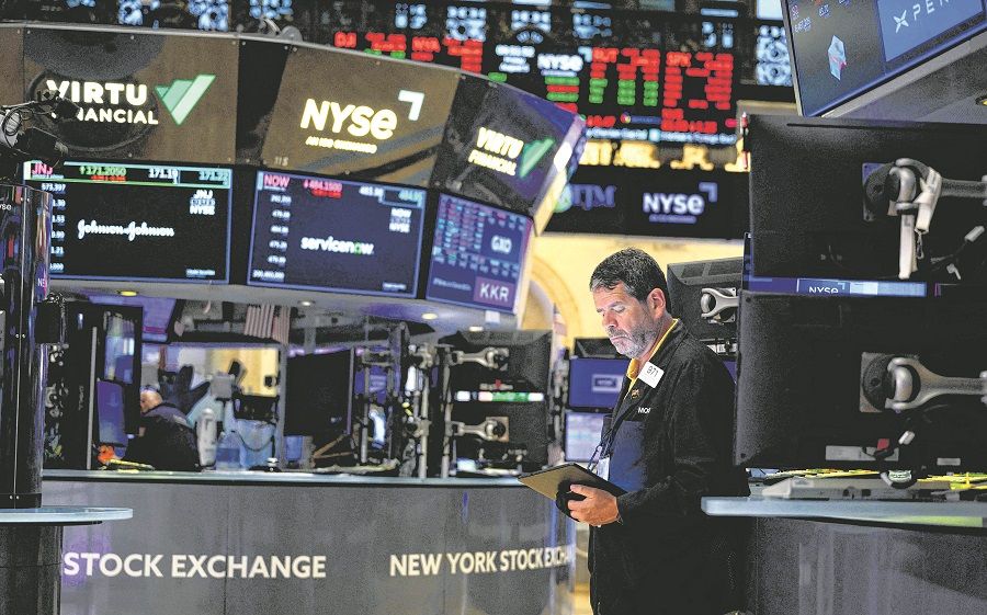 In this file photo taken on 5 August 2022, traders work on the floor of the New York Stock Exchange (NYSE) at Wall Street in New York City, US. (Angela Weiss/AFP)