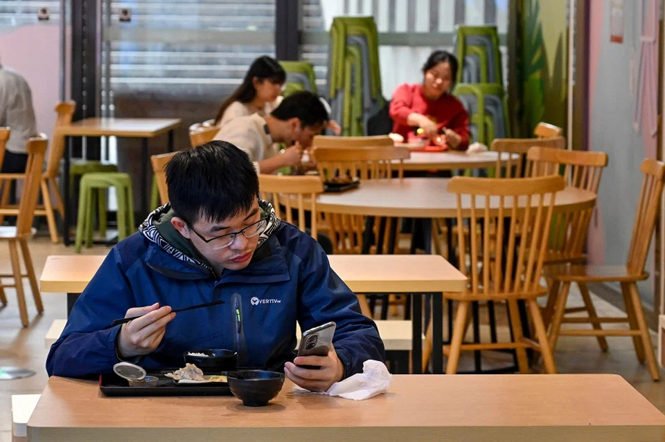 Diners eat in a restaurant in Guangzhou city's Tianhe district in China's southern Guangdong province on 1 December 2022. (CNS/AFP)