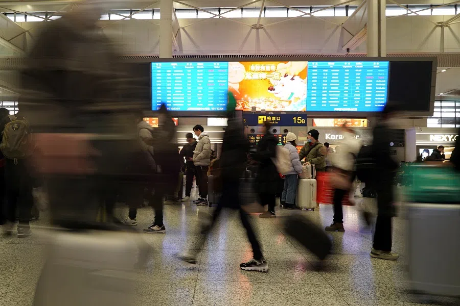 Travellers wait for their trains at Shanghai Hongqiao railway station in Shanghai, China, on 5 February 2024. (Nicoco Chan/Reuters)