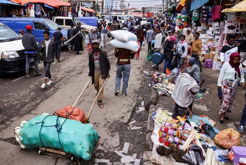 A labourer pushes a handcart at the Mercato open-air marketplace in Ketema, district of Addis Ababa, Ethiopia, 21 July 2022. (Tiksa Negeri/File Photo/Reuters)