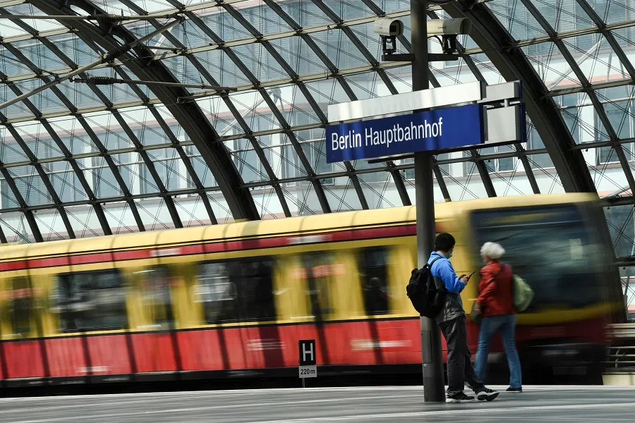 People stand on a platform at Berlin Central Station, in Berlin, Germany, 1 June 2022. (Annegret Hilse/Reuters)