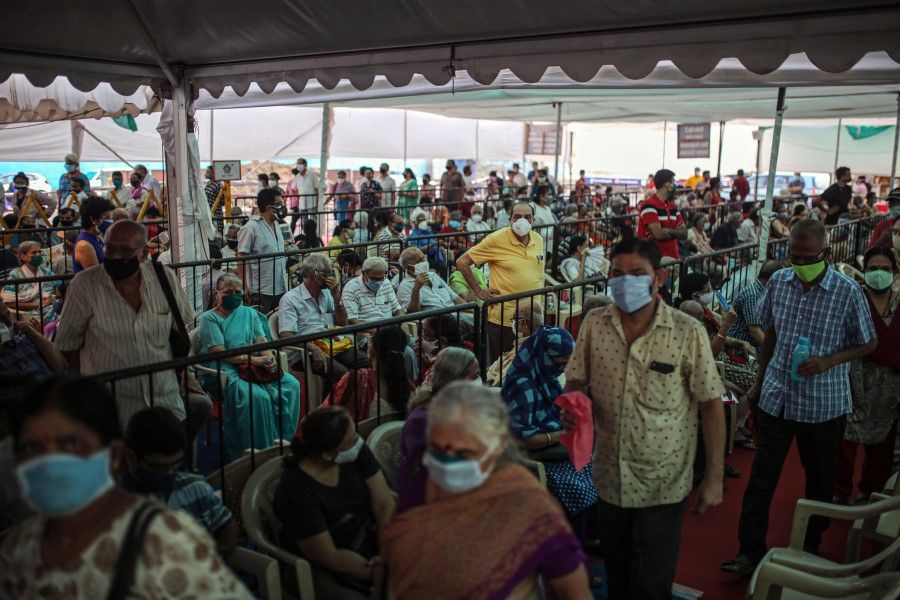 People in a waiting area at a Covid-19 vaccination center at the BKC NESCO jumbo Covid centre in the Goregaon suburb of Mumbai, India, on 27 April 2021. (Dhiraj Singh/Bloomberg)