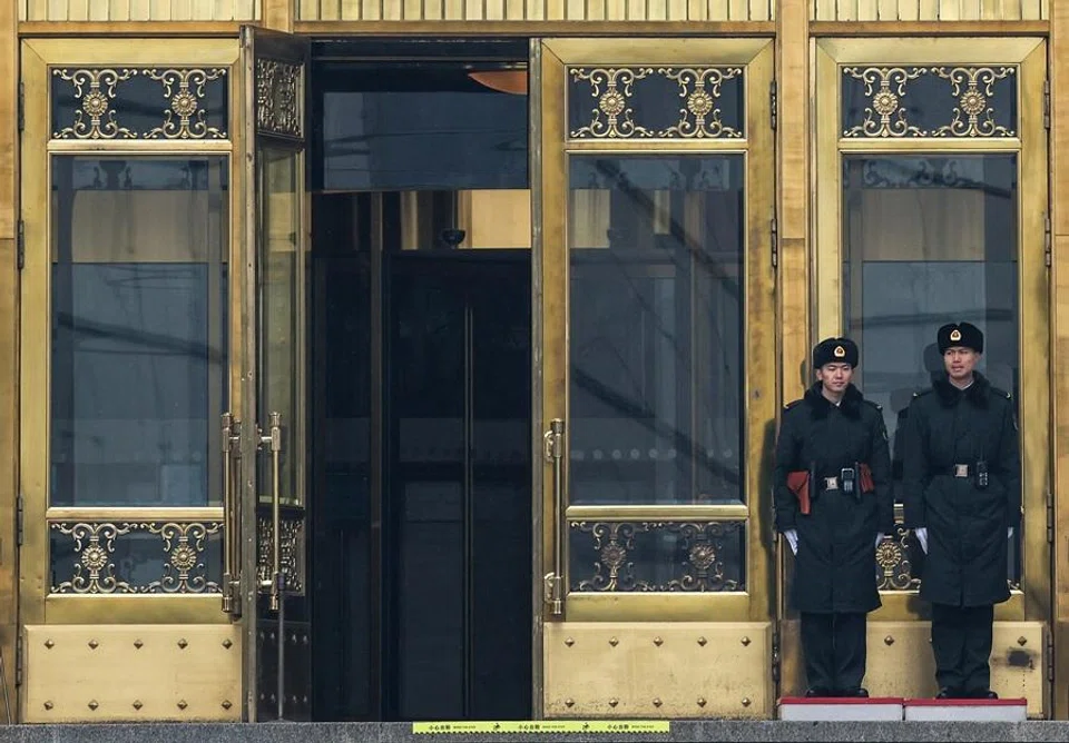 Security officers stand guard at the entrance to the Great Hall of the People ahead of the annual meeting of the National People's Congress, which starts this week, in Beijing, China, on 2 March 2026. (Maxim Shemetov/Reuters)