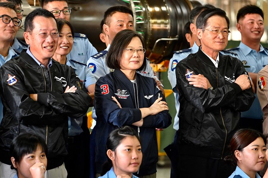 In this file photo taken on 26 September 2020, Taiwan President Tsai Ing-wen (centre) poses for photographs while visiting a turboprop engine factory at a military base in Kaohsiung, Taiwan. (Sam Yeh/AFP)