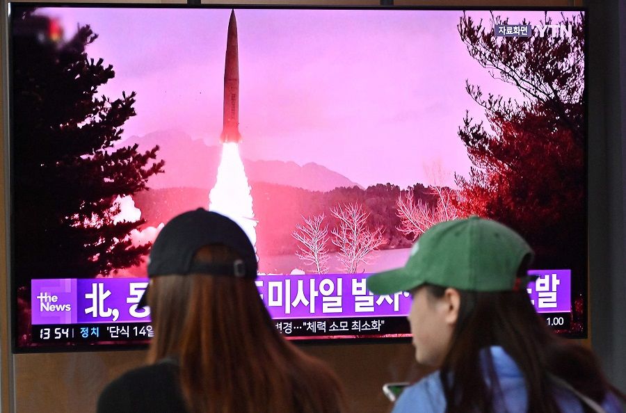 People watch a television screen showing a news broadcast with file footage of a North Korean missile test, at a railway station in Seoul, South Korea, on 13 September 2023. (Jung Yeon-je/AFP)