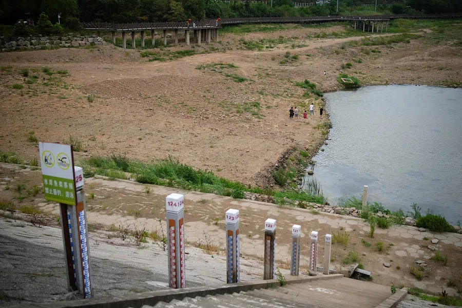 Water level poles emerge after waters receded in a reservoir, amid hot temperatures, while many regions from southwest to east of the country along the Yangtze River have been experiencing weeks of record-breaking heatwave in Changxing, Zhejiang province, China, 20 August 2022. (Aly Song/Reuters)