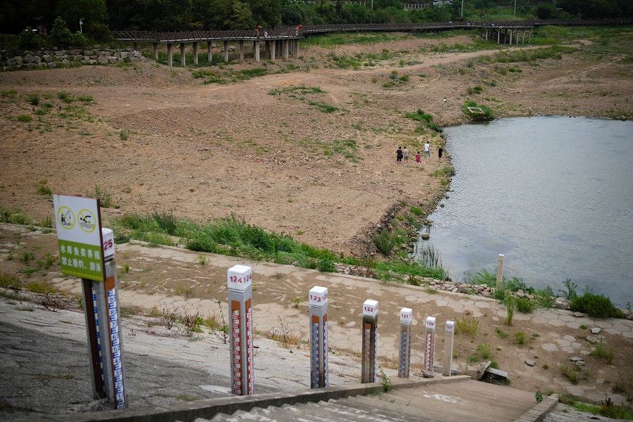 Water level poles emerge after waters receded in a reservoir, amid hot temperatures, while many regions from southwest to east of the country along the Yangtze River have been experiencing weeks of record-breaking heatwave in Changxing, Zhejiang province, China, 20 August 2022. (Aly Song/Reuters)