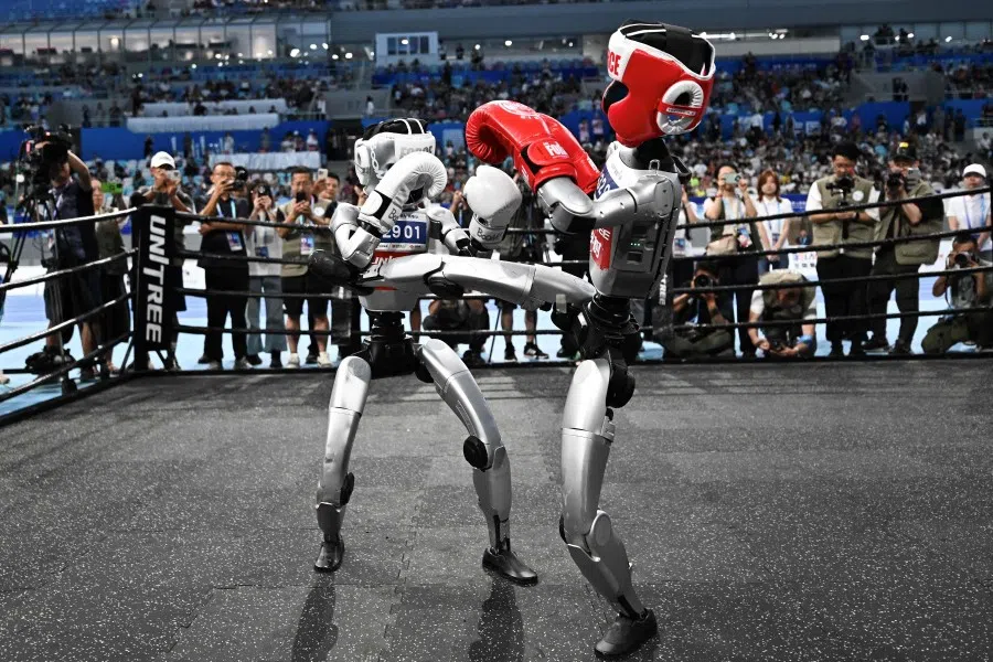 Robots compete in a boxing event during the World Humanoid Robots Games in Beijing on 17 August 2025. (Pedro Pardo/AFP)