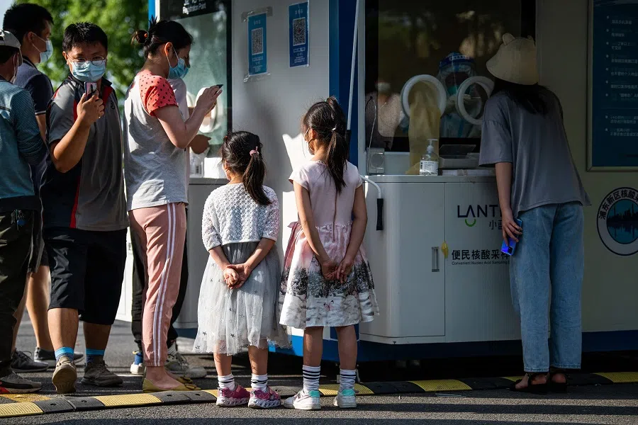 Young girls wait for PCR tests amid Covid-19 restrictions in Shanghai's Pudong district, China, on 31 May 2022. (Liu Jin/AFP)