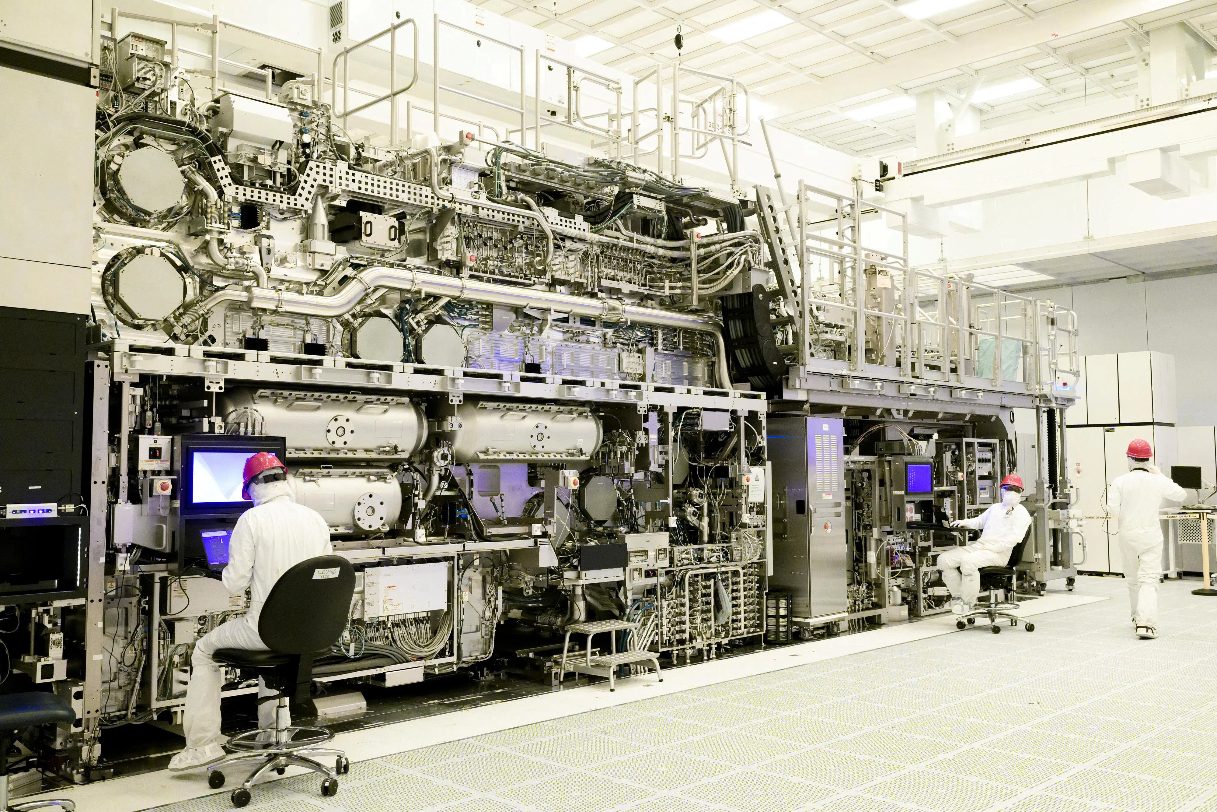 Workers are seen in front of a High NA EUV lithography system at an Intel facility in Hillsboro, Oregon, US in this handout image obtained by Reuters on 19 April 2024.