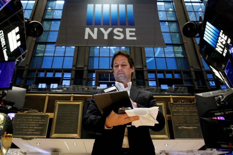 A trader works on the floor of the New York Stock Exchange (NYSE) in New York City, US, 8 December 2021. (Brendan McDermid/Reuters)