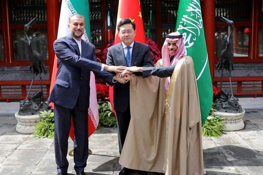 This handout picture provided by the Iranian foreign ministry shows Iran's Foreign Minister Hossein Amir-Abdollahian (left) shaking hands with Saudi Arabia's Foreign Minister Prince Faisal bin Farhan (right) and Chinese Foreign Minister Qin Gang (centre) during a meeting in Beijing on 6 April 2023. (Iranian Foreign Ministry/AFP)